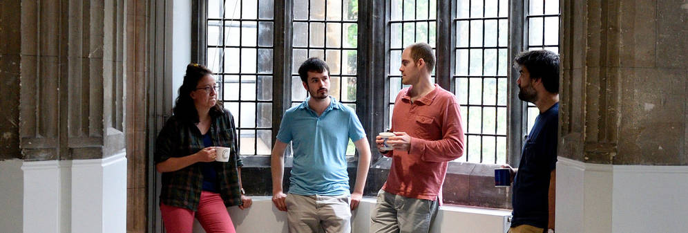 Relaxed group in front of window framed by building